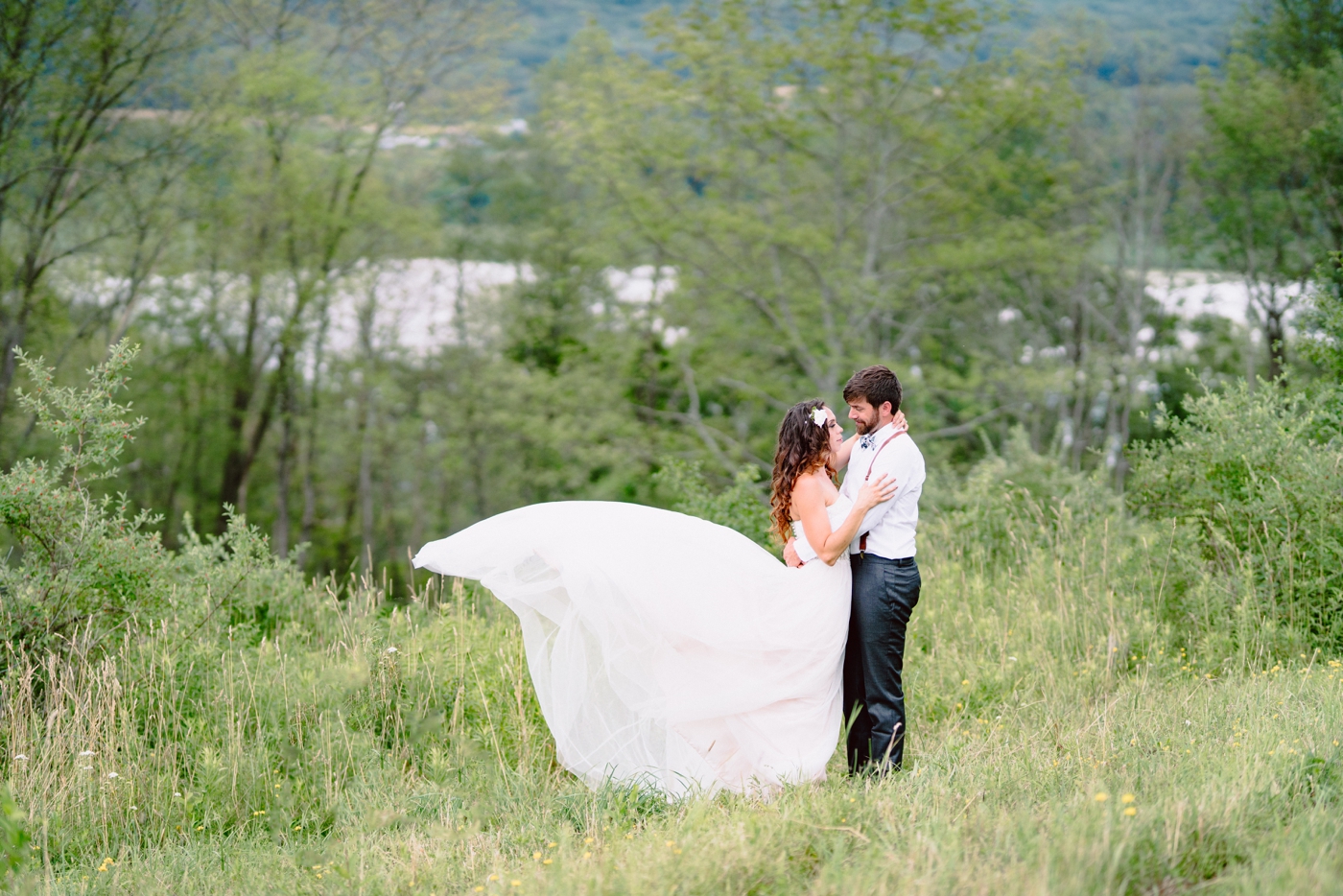 Bride and groom portrait overlooking a lake in Upstate New York