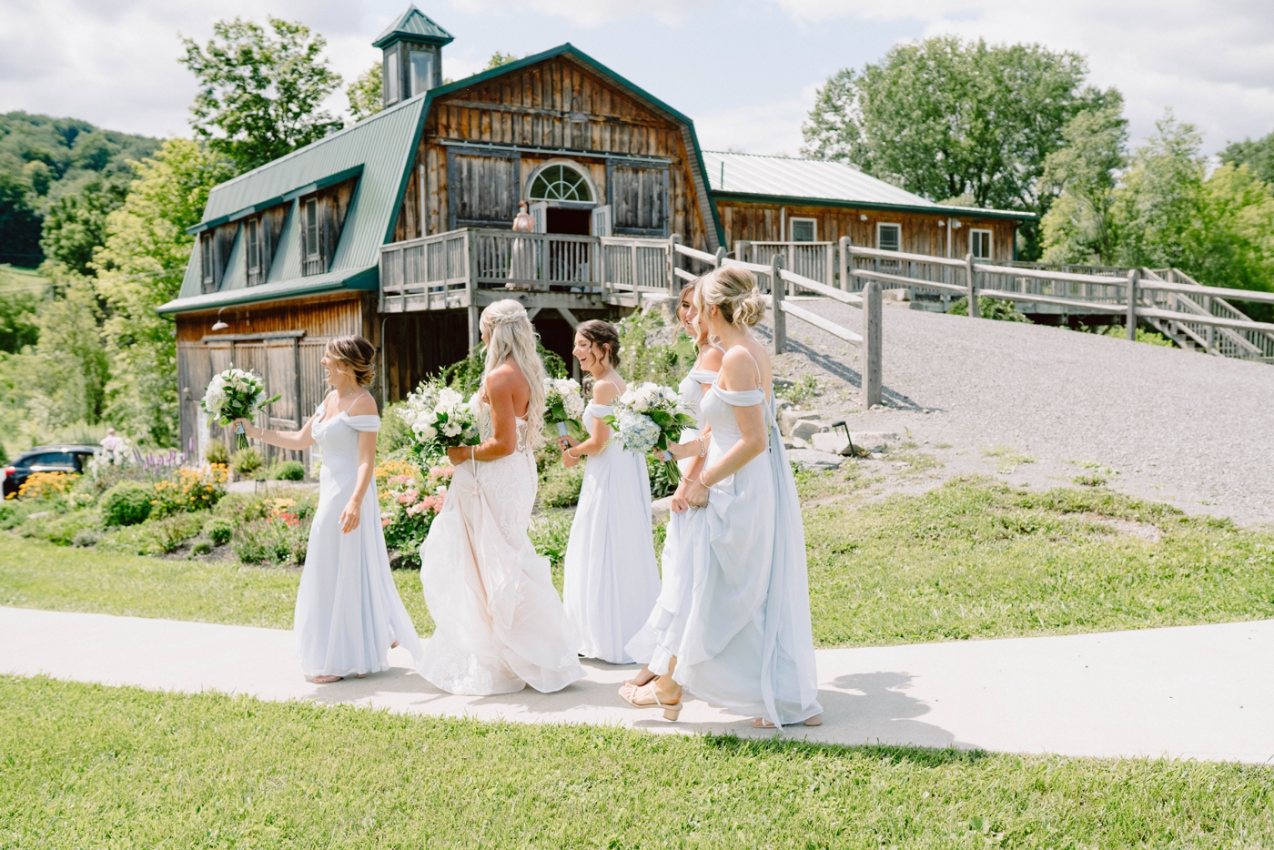 Bridal party portraits at Wolf Oak Acres with bridesmaids in dusty blue dresses