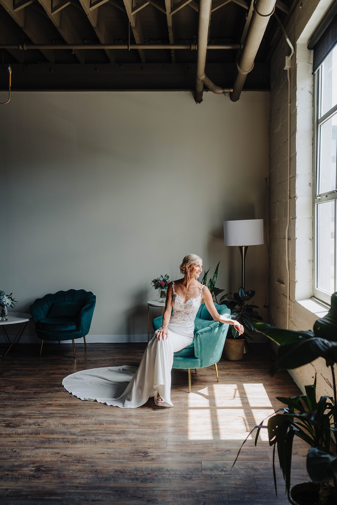 Bride in a sleeveless wedding gown with an A-line skirt and lace bodice from Two Hearts Bridal Shop