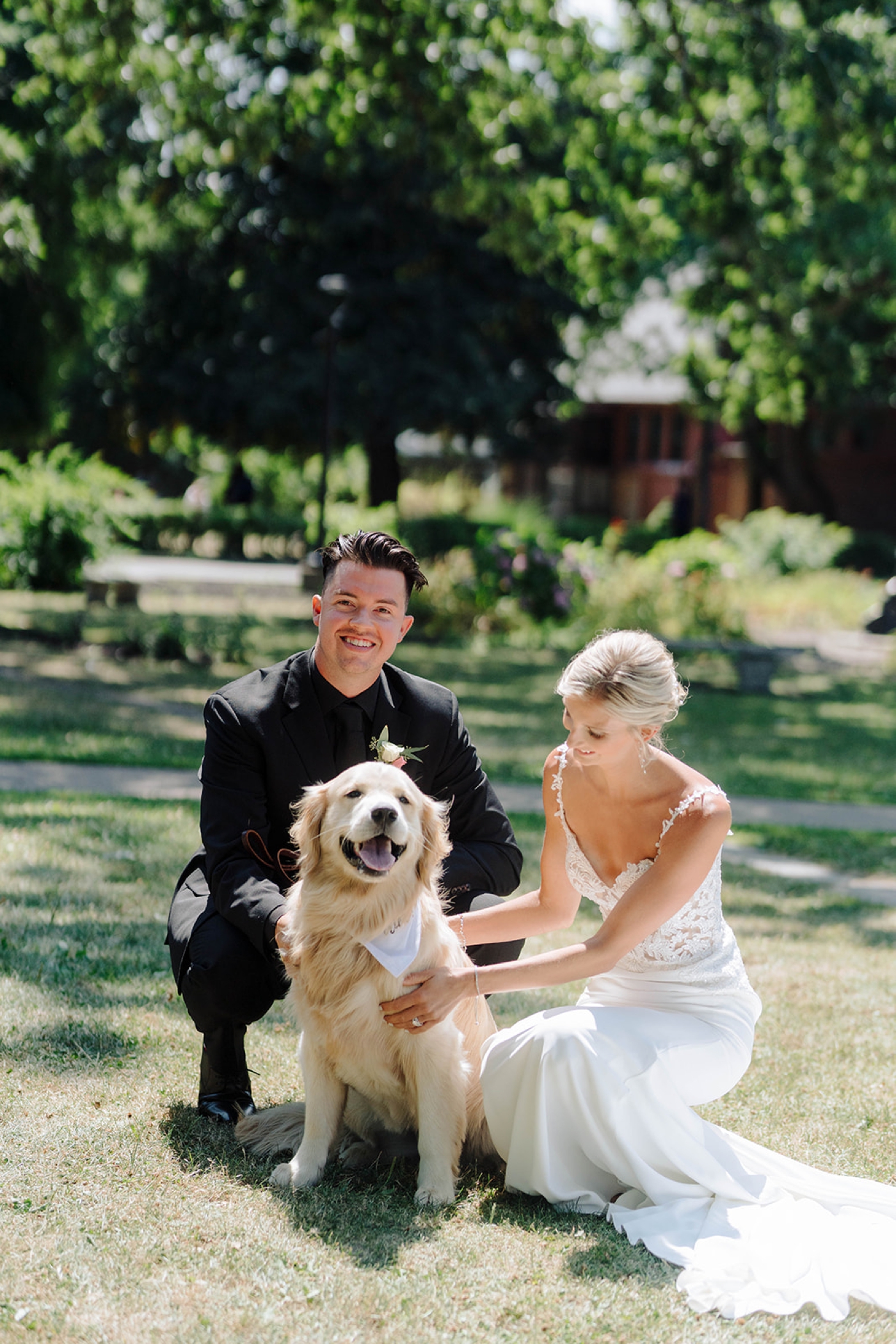 Bride and groom posing with their dog for their bridal portraits